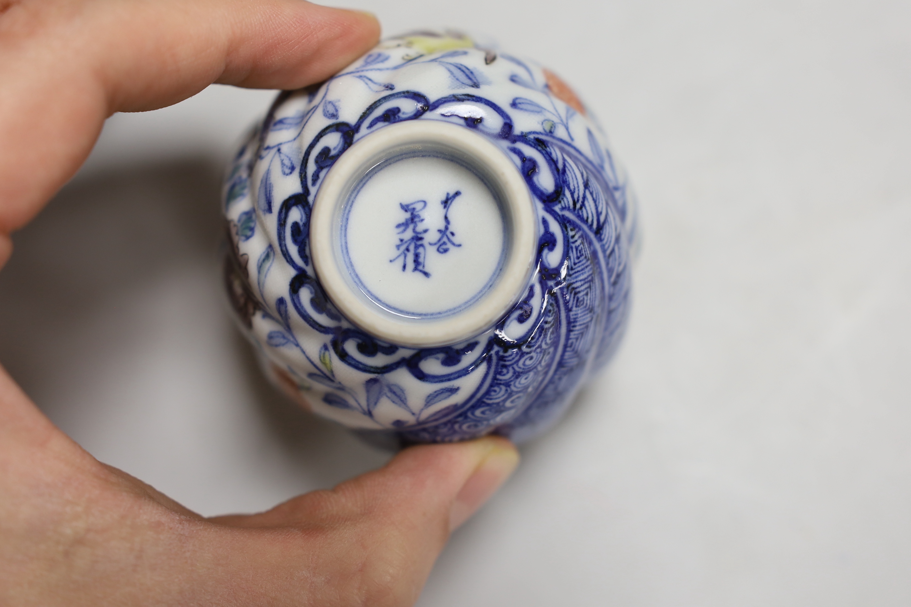 A Chinese cloisonné enamel bowl, a Japanese porcelain tea bowl, an Islamic white metal inlaid pewter box and a bronze figure